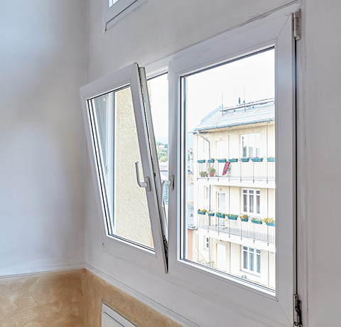 interior window open with view to apartment building features two window panes and a modern design