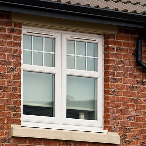 white double glazed window with grid design on brick wall showcasing energy efficiency features for homes including 26 window styles