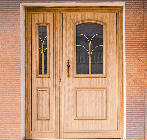 wooden front door with decorative glass panes inviting entry to home or apartment with four elegant design features