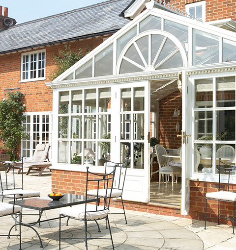 sunlit garden conservatory with glass features seating area and potted plants ideal for relaxation and gatherings inspired by design techniques 22