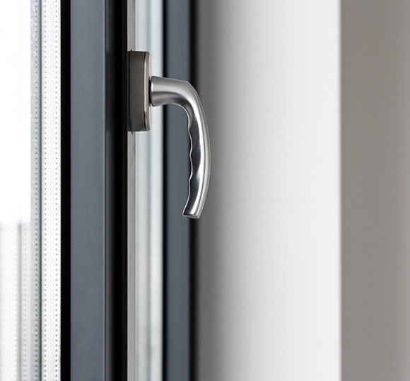 modern window handle positioned on the glass frame with a sleek design suitable for twelve styles of architecture