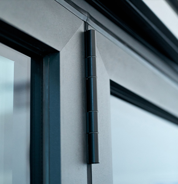 close up of a modern door hinge in sleek black design showcasing detail and craftsmanship suitable for thirteen styles of architecture