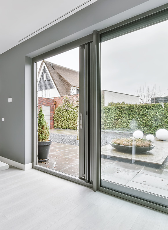 modern interior view of a spacious room with large sliding glass doors revealing a green garden and stone pathway perfect for 13 dream home ideas
